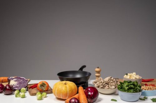 Studio composition of fresh vegetables and a frying pan, ideal for healthy cooking and recipe preparation.
